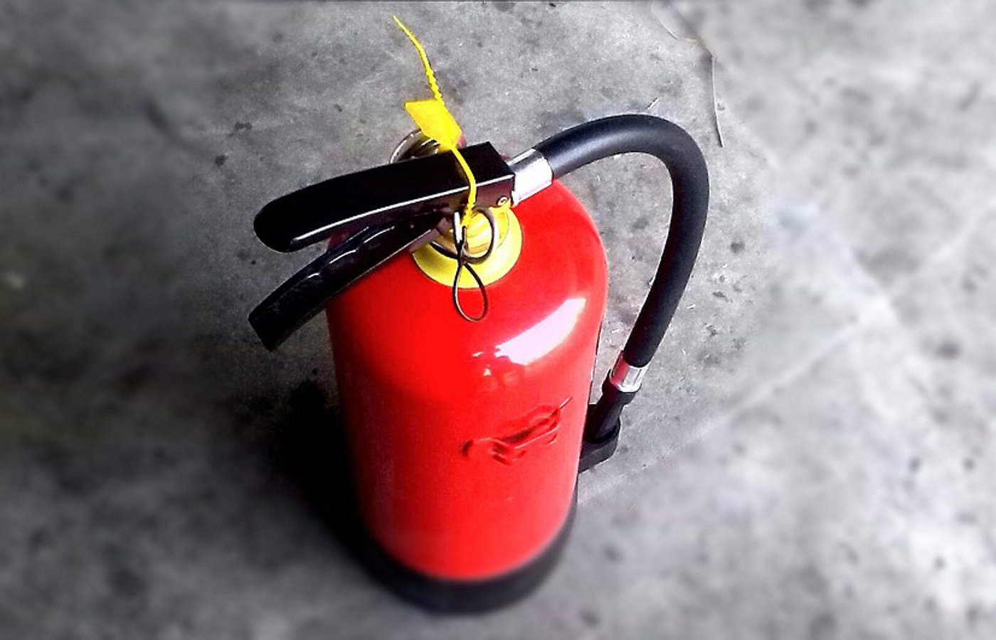 ABC dry-chemical fire extinguisher on a commercial wall mount